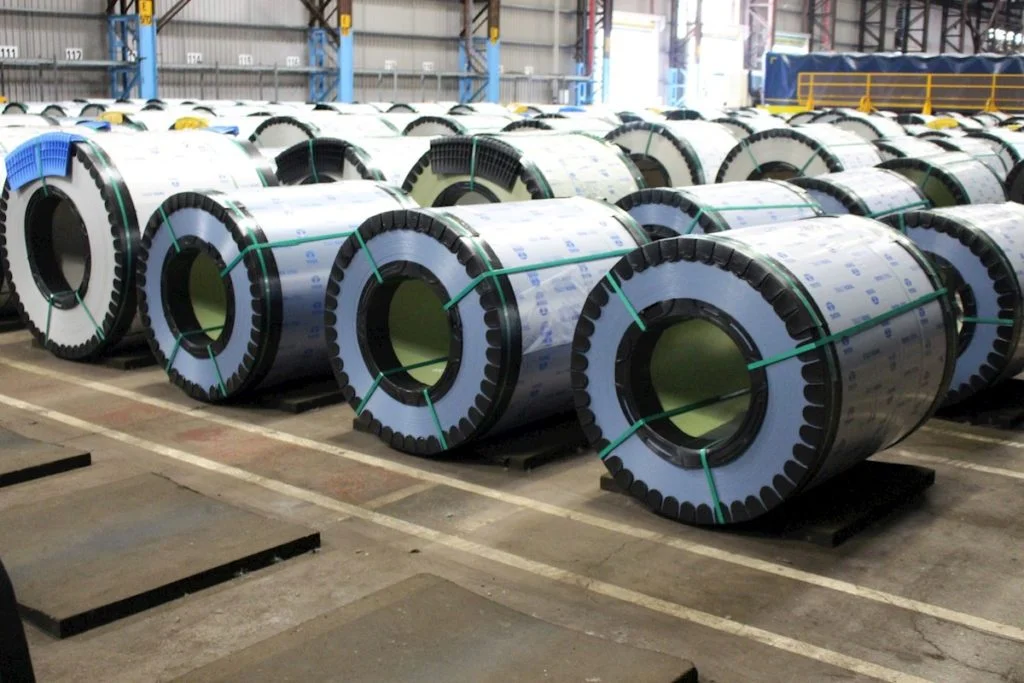 Many rolls of steel coils in a warehouse.