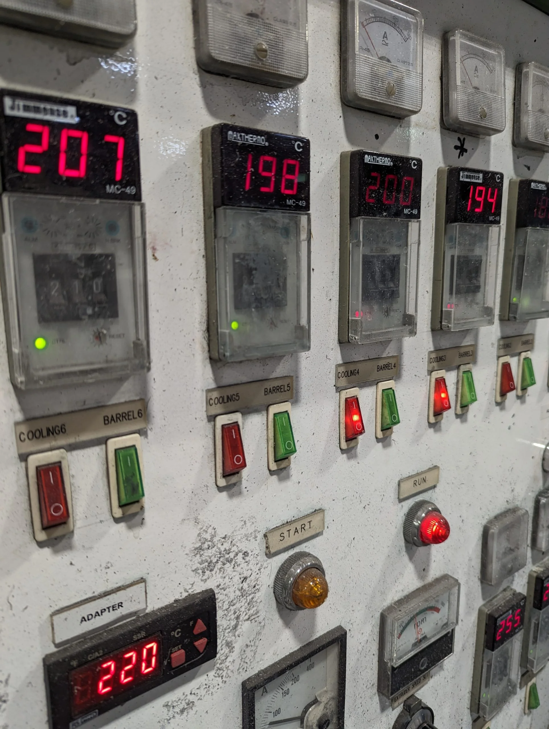 A control panel with a lot of different gauges on it.