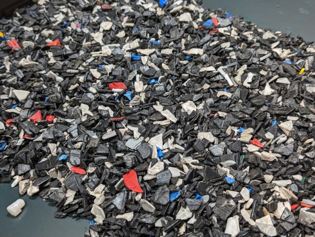 A pile of black, blue, and red plastic pieces.