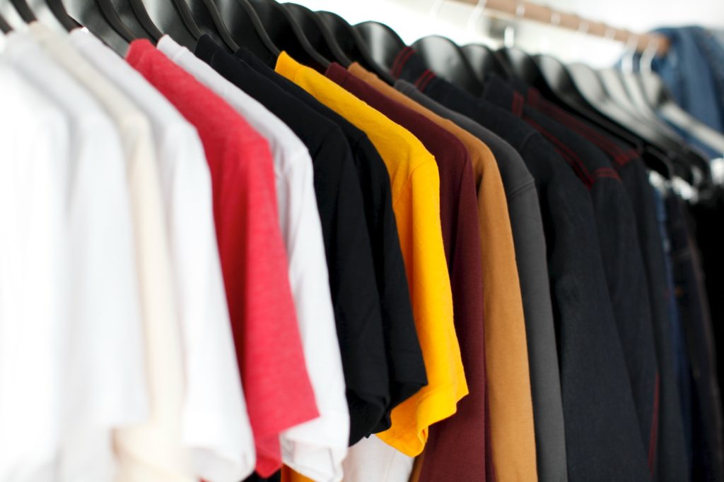 A rack of t - shirts on a hanger.