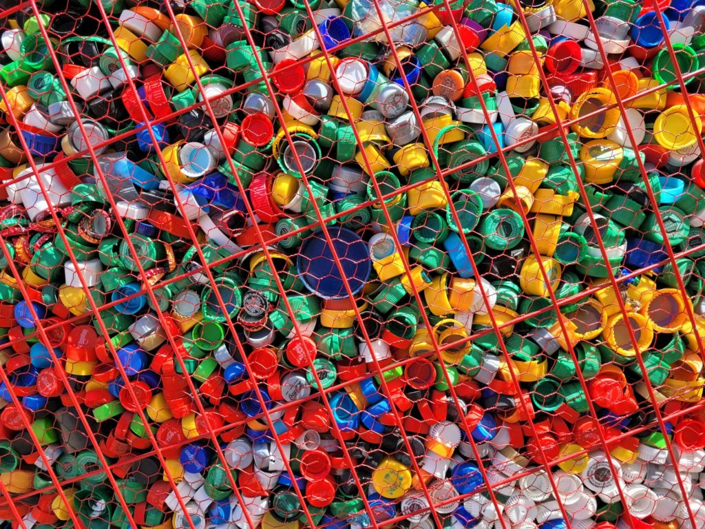 Colorful crushed plastic bottles sorted for recycling.